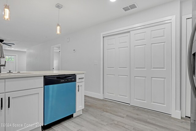702 S Myrtle Ave, New Smyrna Beach, FL 32168 - kitchen featuring light countertops, light wood-style floors, pendant lighting, visible vents, and dishwasher