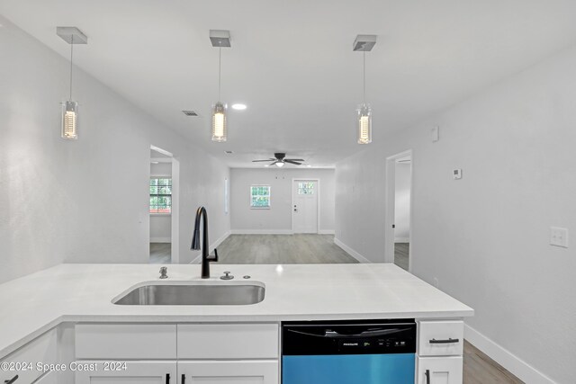 702 S Myrtle Ave, New Smyrna Beach, FL 32168 - kitchen with white cabinetry, a sink, light wood-style floors, ceiling fan, and dishwasher