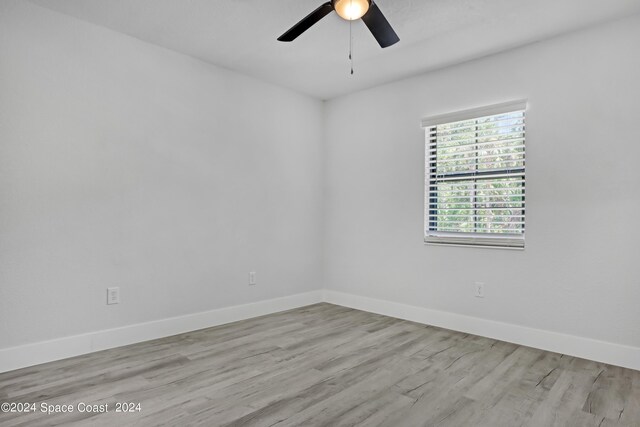 702 S Myrtle Ave, New Smyrna Beach, FL 32168 - unfurnished room with baseboards, wood finished floors, and ceiling fan