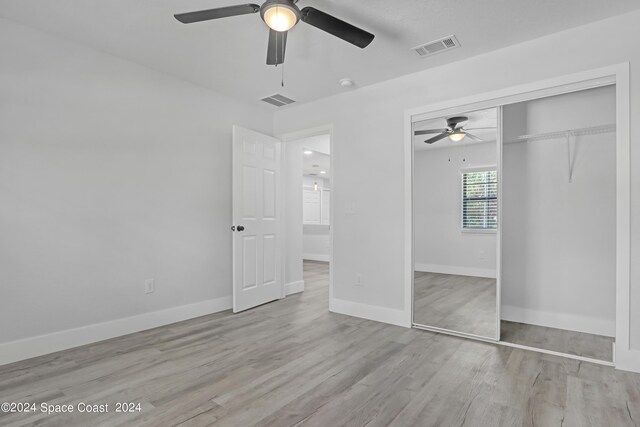 702 S Myrtle Ave, New Smyrna Beach, FL 32168 - unfurnished bedroom featuring baseboards, visible vents, a closet, and wood finished floors