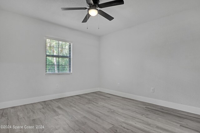 702 S Myrtle Ave, New Smyrna Beach, FL 32168 - empty room with baseboards, wood finished floors, and ceiling fan