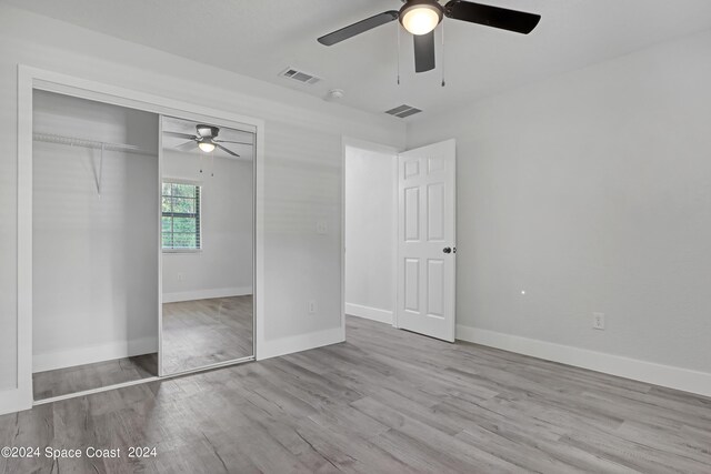 702 S Myrtle Ave, New Smyrna Beach, FL 32168 - unfurnished bedroom with visible vents, a closet, and wood finished floors
