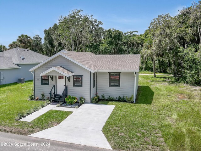 ranch-style home with cooling unit and a front yard