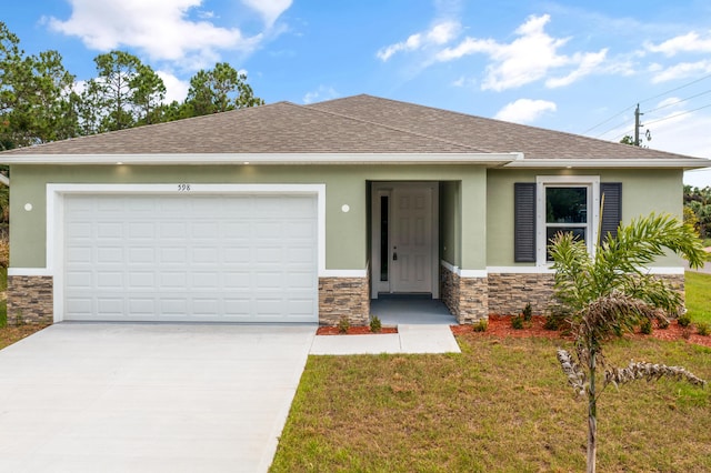 view of front of property with a front yard and a garage