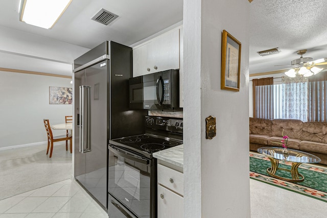 kitchen with ceiling fan, black appliances, a textured ceiling, light colored carpet, and white cabinetry