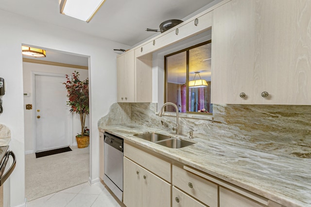 kitchen with light stone countertops, stainless steel dishwasher, light colored carpet, backsplash, and sink