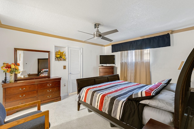 carpeted bedroom featuring ceiling fan and a textured ceiling