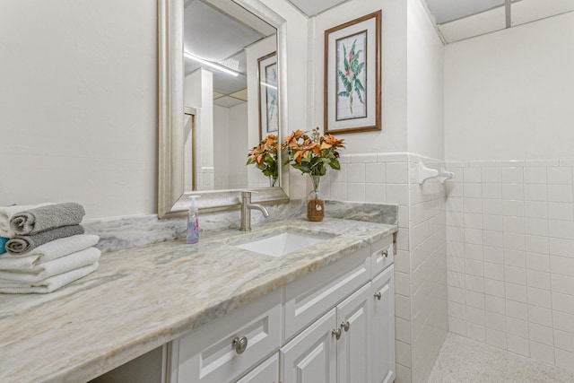 bathroom featuring tile walls and vanity