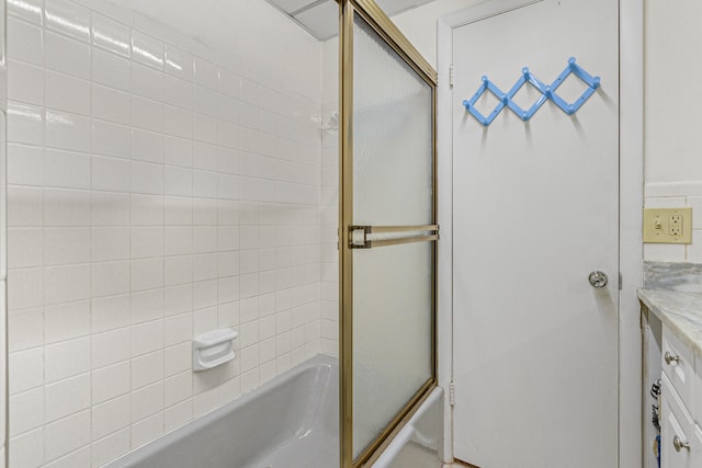 bathroom with vanity and bath / shower combo with glass door