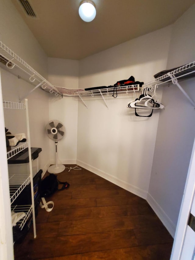 walk in closet with hardwood / wood-style floors