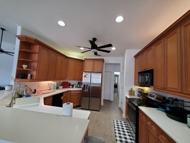 kitchen featuring kitchen peninsula, ceiling fan, sink, black appliances, and light tile patterned floors