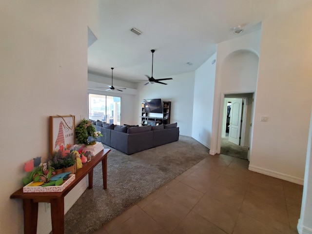 tiled living room with ceiling fan