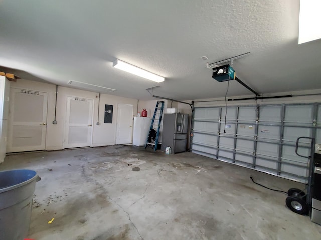 garage with electric panel, stainless steel fridge, and a garage door opener