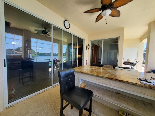 view of patio with a water view and an outdoor bar