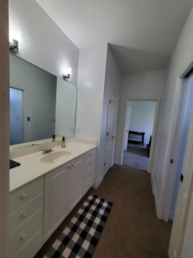 bathroom featuring tile patterned flooring and vanity