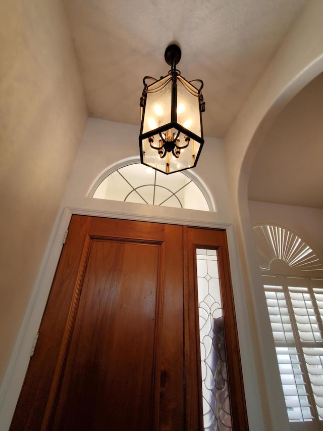 foyer entrance with a chandelier