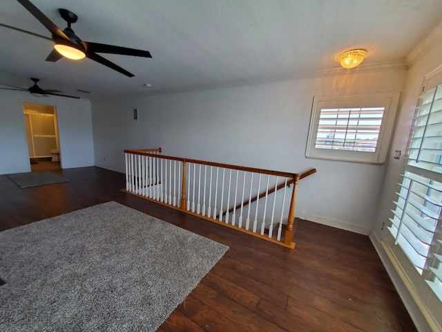 spare room featuring ceiling fan, dark hardwood / wood-style flooring, and ornamental molding