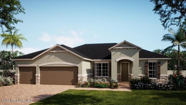 view of front of house with a front yard and a garage