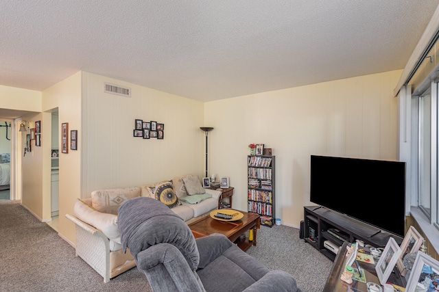 carpeted living room featuring a textured ceiling