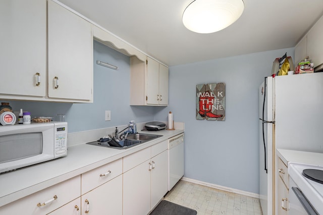 kitchen with white appliances, sink, white cabinetry, and light tile floors