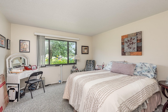 bedroom featuring carpet and a textured ceiling