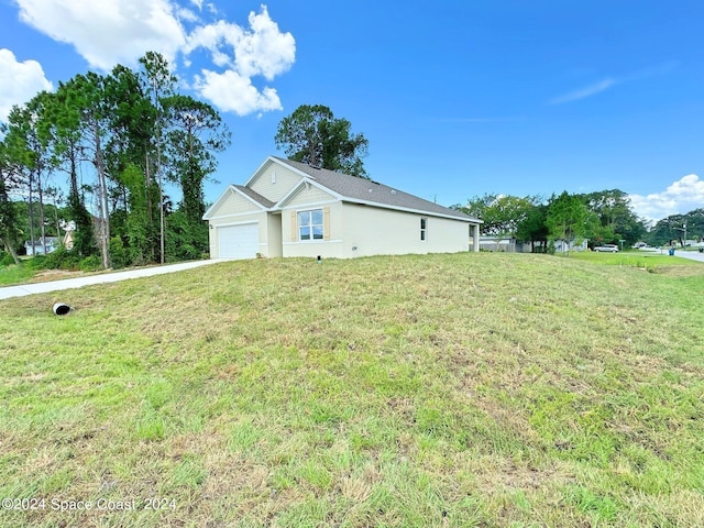 view of front of property featuring a garage and a front lawn