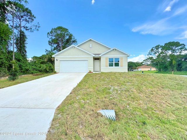 view of front of property with a garage and a front lawn