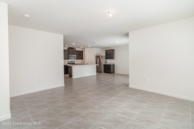 unfurnished living room featuring light tile patterned floors