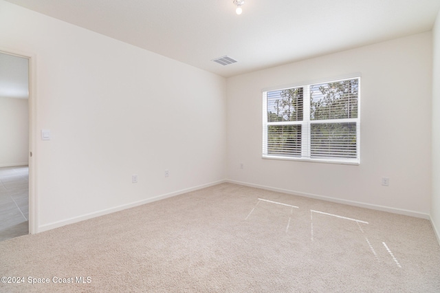 unfurnished room with light carpet