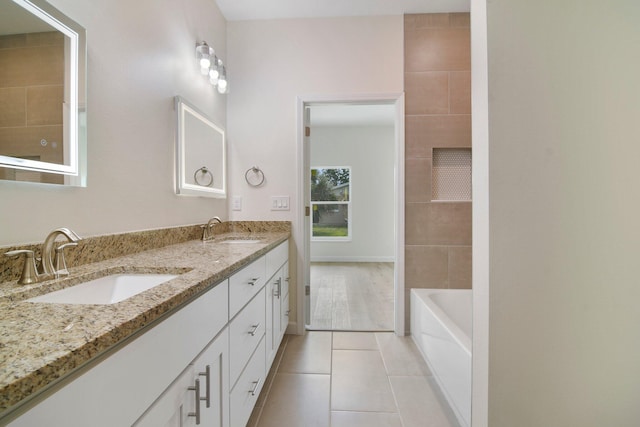 bathroom featuring tile flooring, oversized vanity, and dual sinks