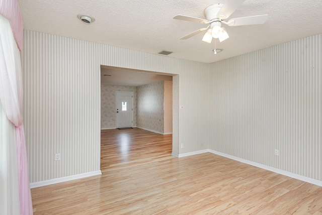 spare room featuring ceiling fan and light hardwood / wood-style flooring