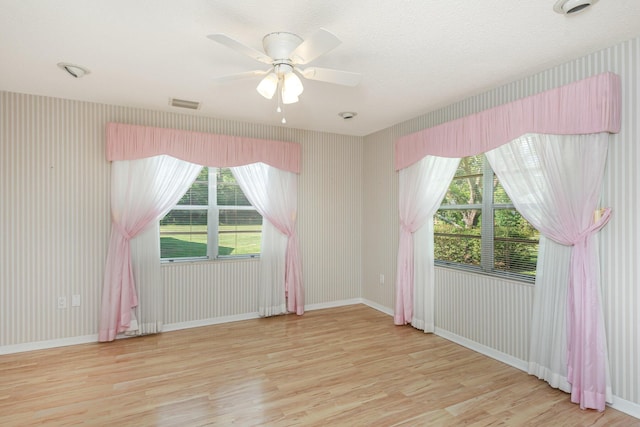 spare room with light wood-type flooring and ceiling fan