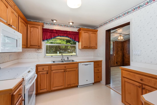 kitchen featuring white appliances and sink