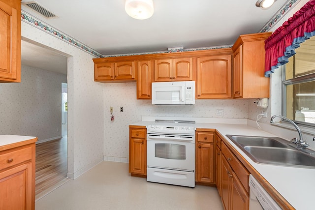 kitchen with white appliances and sink