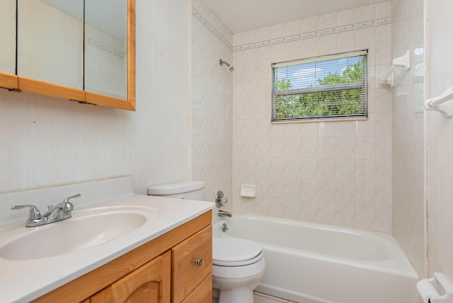 full bathroom with toilet, vanity, and tiled shower / bath