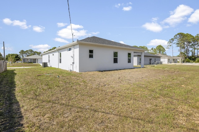 view of property exterior with central AC unit and a lawn