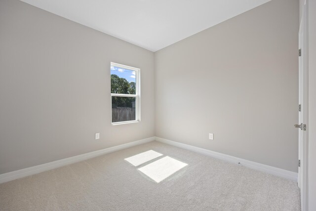 empty room featuring light carpet