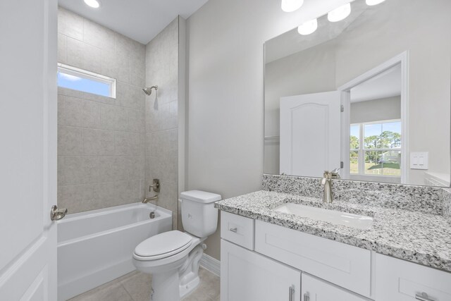 full bathroom featuring tiled shower / bath combo, vanity, plenty of natural light, and tile patterned flooring