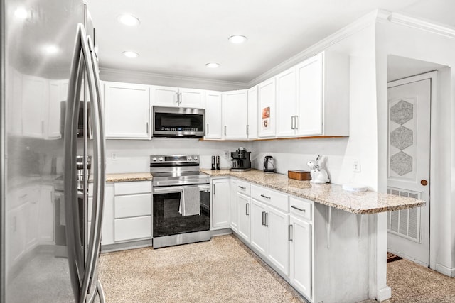 kitchen featuring light stone countertops, crown molding, white cabinetry, and stainless steel appliances