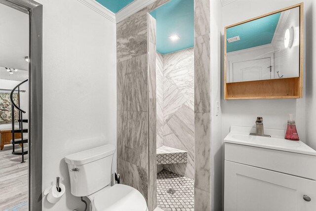 1557 Hillcrest Dr, Melbourne, FL 32935 - full bathroom featuring a tile shower, crown molding, vanity, and toilet
