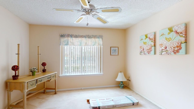 interior space featuring carpet flooring, ceiling fan, and a textured ceiling