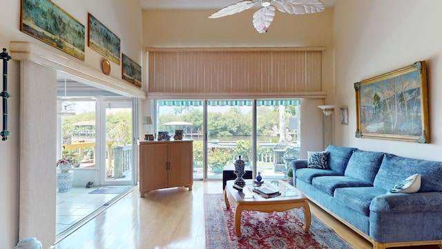 living room featuring a wealth of natural light, hardwood / wood-style floors, and ceiling fan