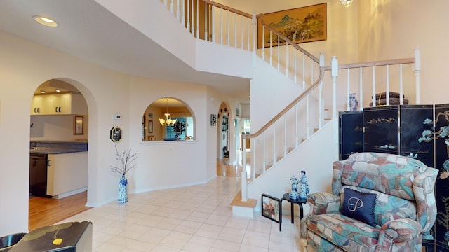 entryway with a chandelier and light tile patterned floors