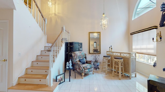 interior space with a towering ceiling and an inviting chandelier