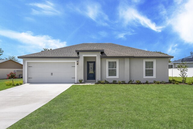 view of front of home with a garage and a front yard