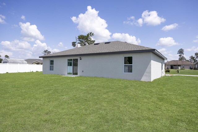 rear view of house with a lawn