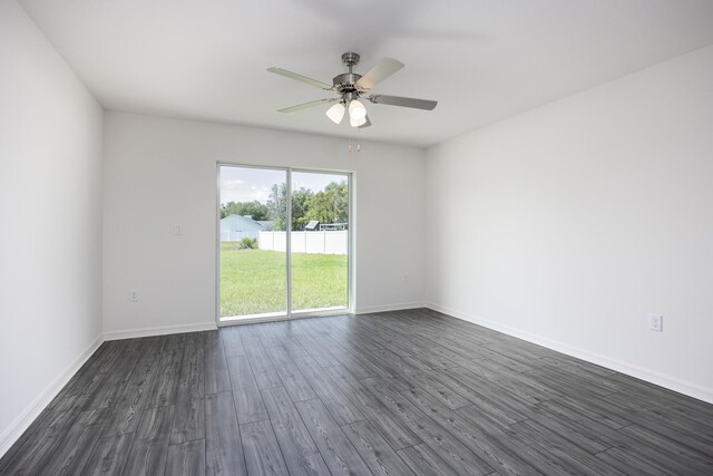 spare room with dark wood-type flooring and ceiling fan