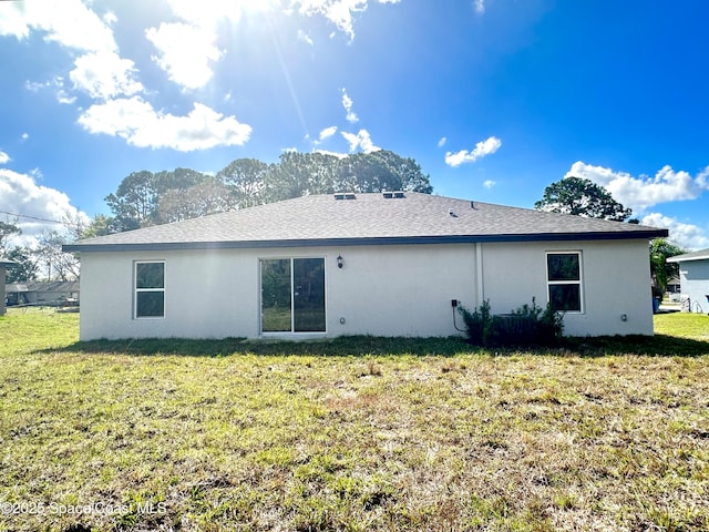 rear view of house with a yard