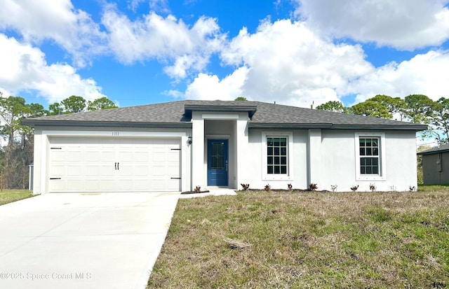 view of front of house with a garage and a front lawn