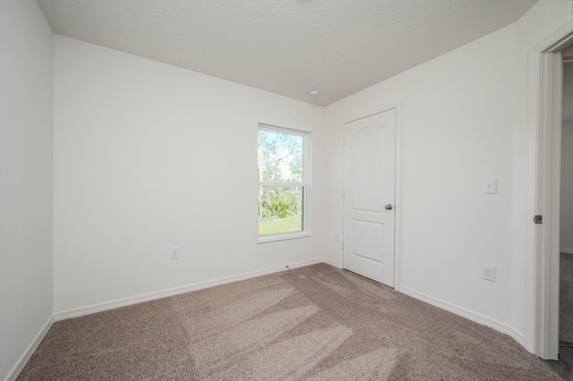 unfurnished bedroom with carpet flooring and a textured ceiling